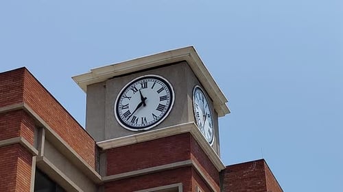 Clock tower against blue sky – Static shot of architecture & roman numerals - Vadodara