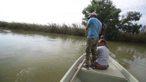 Men Fishing on River Boat Catch Fish