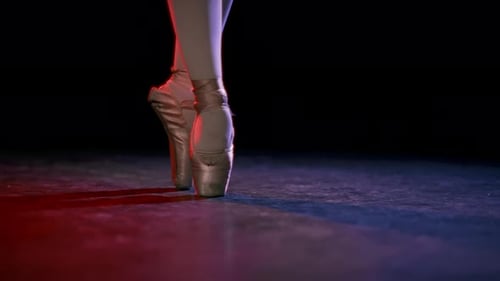 Closeup View of Ballerina Feet in Pointe Shoes in Rehearsal Room or Stage Professional Female Ballet