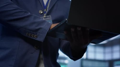 Close Up Shot of Worker Looking for Data Center Network Issues Using Laptop