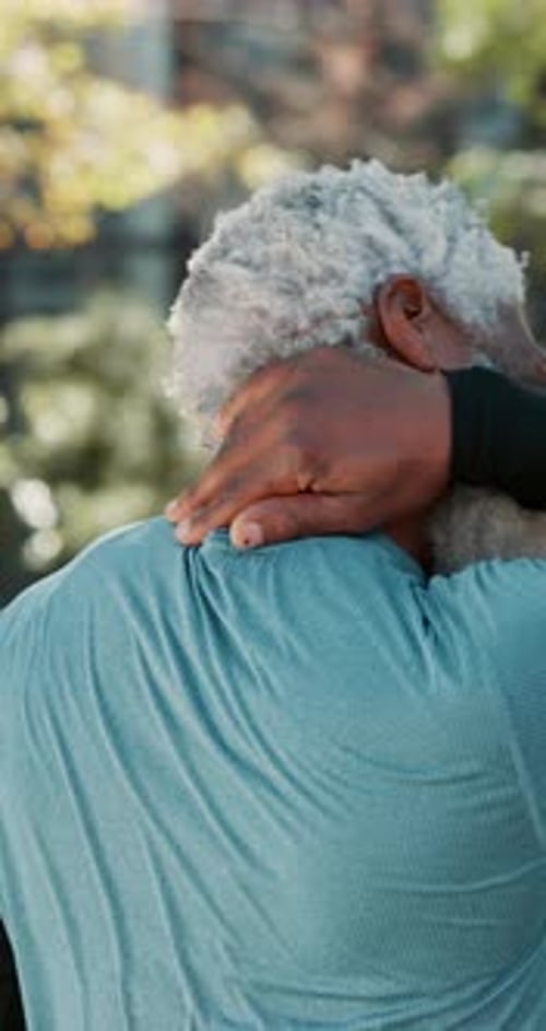 Senior Man Stretching Neck Outdoors
