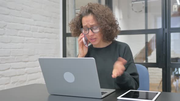 Angry Hispanic Woman Talking on phone at Work, Business, Corporate