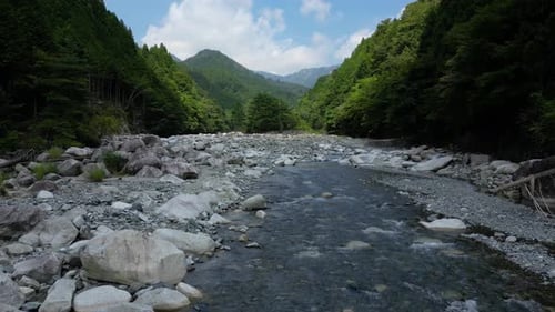 Incredible low angle drone at natural riverbed with clear water river