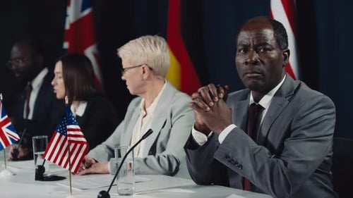 Portrait of Black Male Politician with Clasped Hands at International Summit
