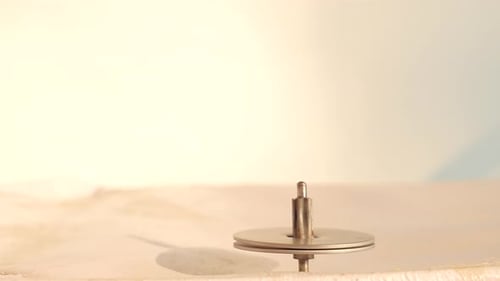 Spinning toy iron a rounding string also called lattoo in india. Its a kids game rounding fast.