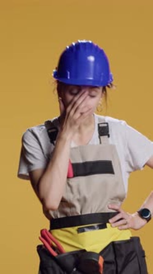 Vertical Video Portrait of Tired Drained Handywoman Yawning After Building Work