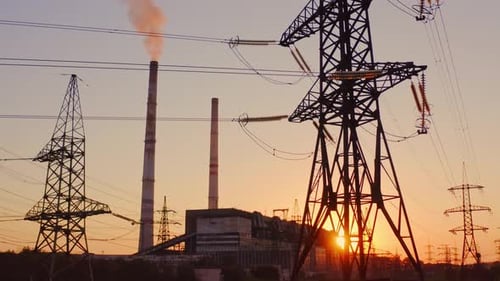 Beautiful sunset over power lines. High voltage power tower landscape at sunset