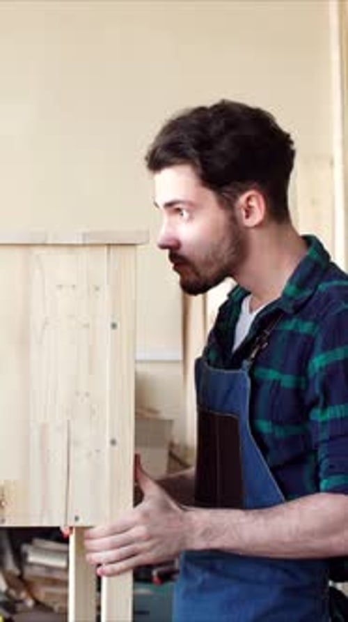 Carpenter Conducting Visual Inspection of Wood Products Working with Wooden Products in Workshop