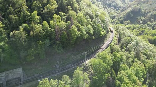 Aerial view of train on tracks near tunnel, France.