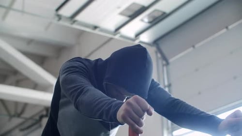 Tired Athlete is Resting After Exercise Doing Slopes and Breathing in Gym