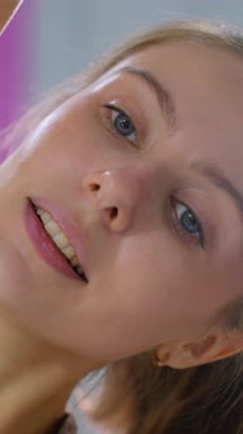 CloseUp of Woman Stretching During Fitness Workout with Bright Gym Lights