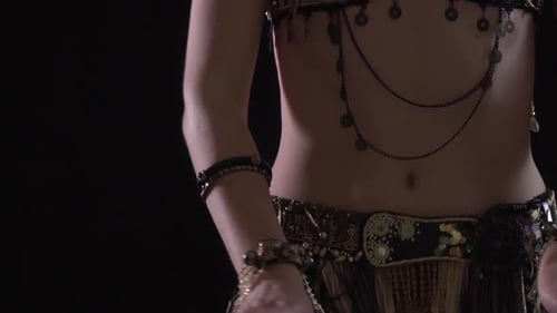 Woman in Belly Dancing Costume Adjusts Belt