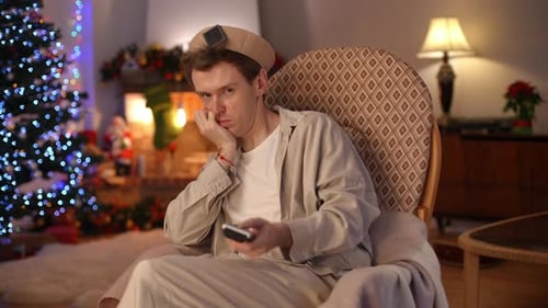 Portrait of Sad Bored LGBT Man Looking at Camera Talking Turning Off TV with Remote Control Sighing