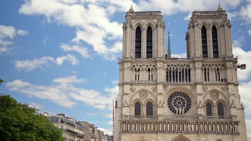 The facade of the Cathedrale Notre-Dame de Paris in France with the blue sky on the background