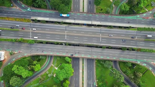 A freeway with a large bridge over it and a city in the background