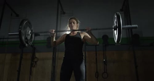 Extreme athletics - Female athlete dramatically dropping weights