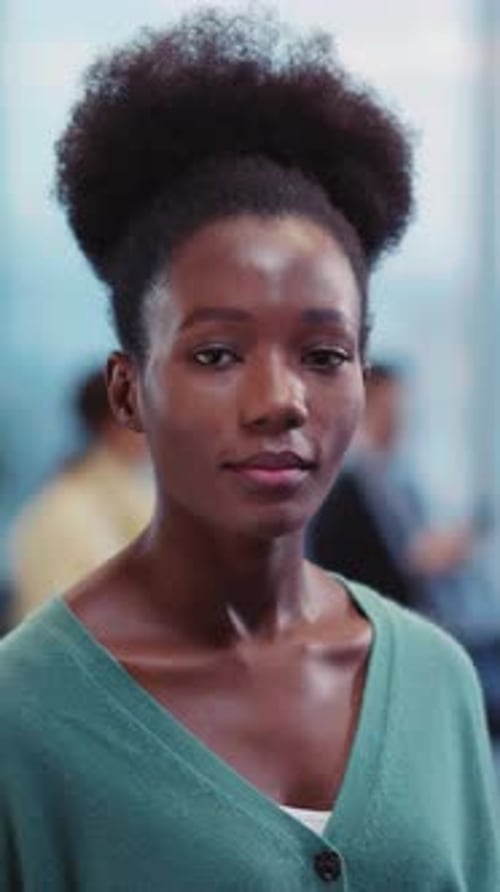 A Confident Woman in a Green Cardigan Invites Connection with Charm