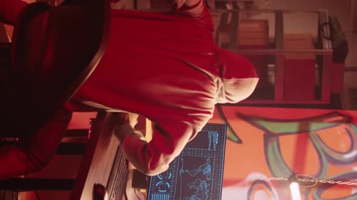 Person Looks at Computer Code in Graffiti Room