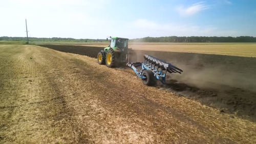 Tractors plowing the field in Ukraine