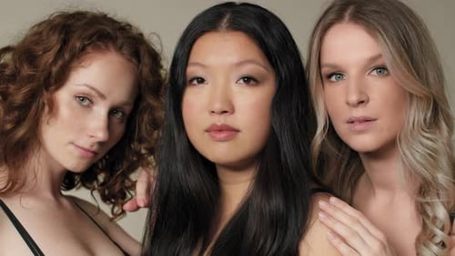Close up of three women standing close and looking towards the camera. Shot with RED helium camera i