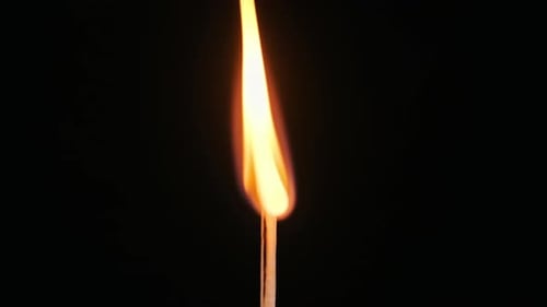 Burning Match Stick on Black Background