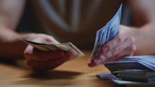 Close Up Man Trader or Businessman Counts Salary Usd Banknotes at Home with His Hands Male