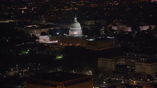 United States capitol building shines at night in Washington dc aerial view