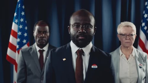 Serious Politicians Standing Before American Flags