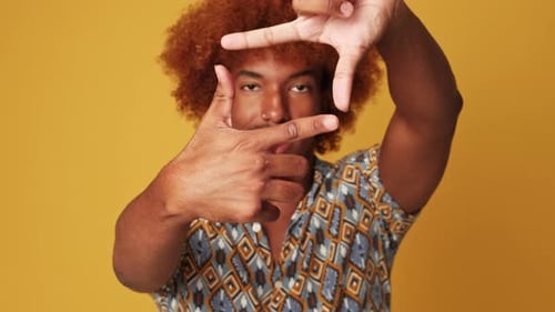Young Adult Smiling Framing Face with Hands
