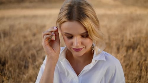 Fair-Haired Woman with Wheat Stalk in Golden Field