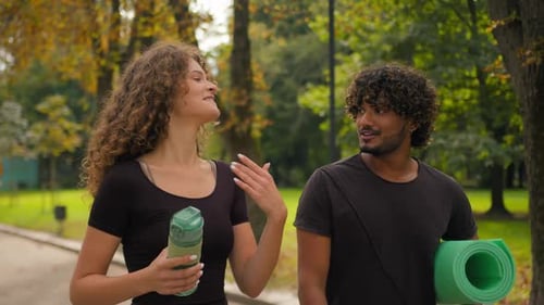 Young Adults Walking and Talking in Green Park