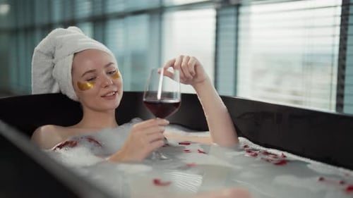 Woman Relax in Milk Bath Drinking Wine Girl Added Eye Patches Resting Lying in Bath with Rose Petals