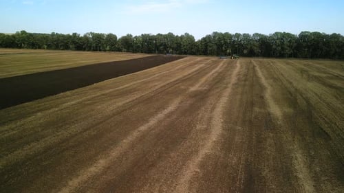 Tractors plowing the field in Ukraine