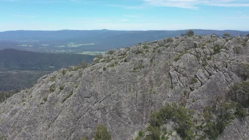 Beautiful orbiting aerial of Sugarloaf peak and green valley below