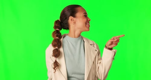 Hand pointing, green screen and happy woman face in studio for announcement