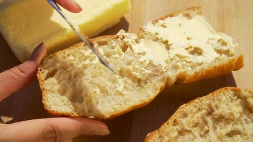Spreading Butter on Slice of Bread Close Up