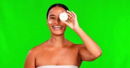 Face, cream and skincare for woman on green screen for beauty, product and healthy dermatology