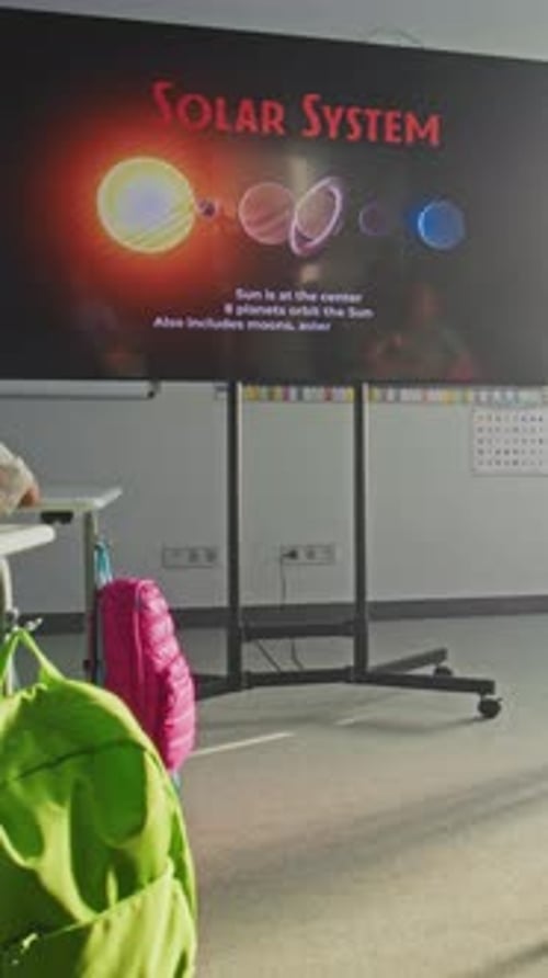 Astronomy Class Female Teacher Explaining Solar System to Primary School Children Using Digital