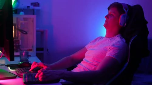 Young Adult Playing a Computer Game at Home