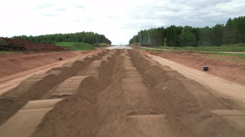 A Pile of Sand Brought By Dump Trucks for Road Construction Aerial View