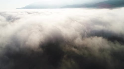 Majestic Cloudscape Rolling Over Mountain Range
