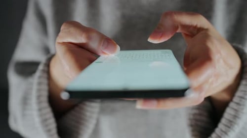 Hands Typing on Smartphone Keyboard Close Up
