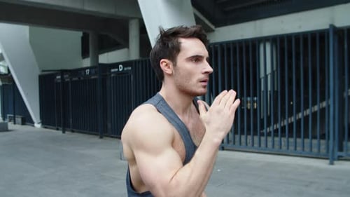 Closeup Fit Man Running On Urban Street In Slow Motion. Close Up Male Runner Jogging In Morning T...