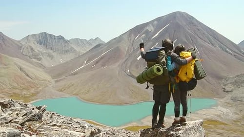 Couple Celebrate Together Reaching Top Mountain