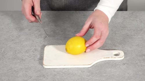 Slicing a Lemon on a Cutting Board