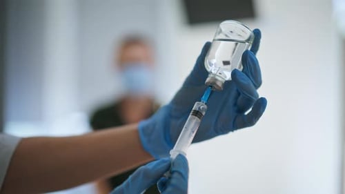 Doctor Hands Taking Vaccine Holding Medical Syringe Injecting in Woman Closeup
