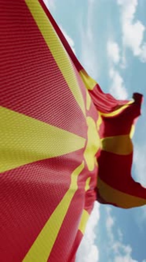Realistic North Macedonia Flag Waving against Blue Sky