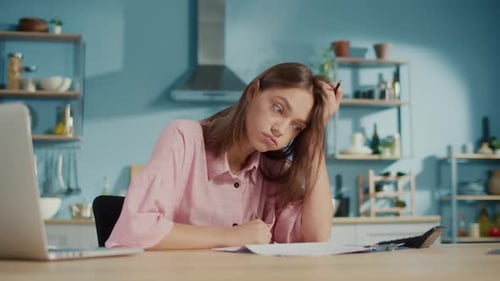 Frustrated Young Woman Accountant Use Calculator to Check Sums in Annual Report