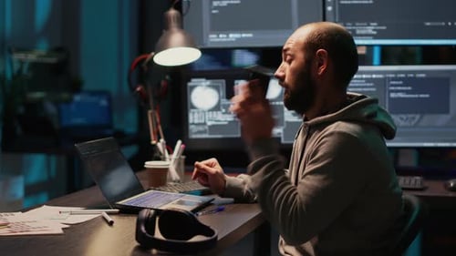 Male Developer Answering Phone Call in Office