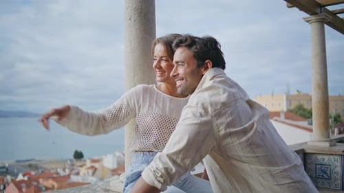 Joyful Newlyweds Looking Distance Laughing at Sea View Terrace Vacation Closeup